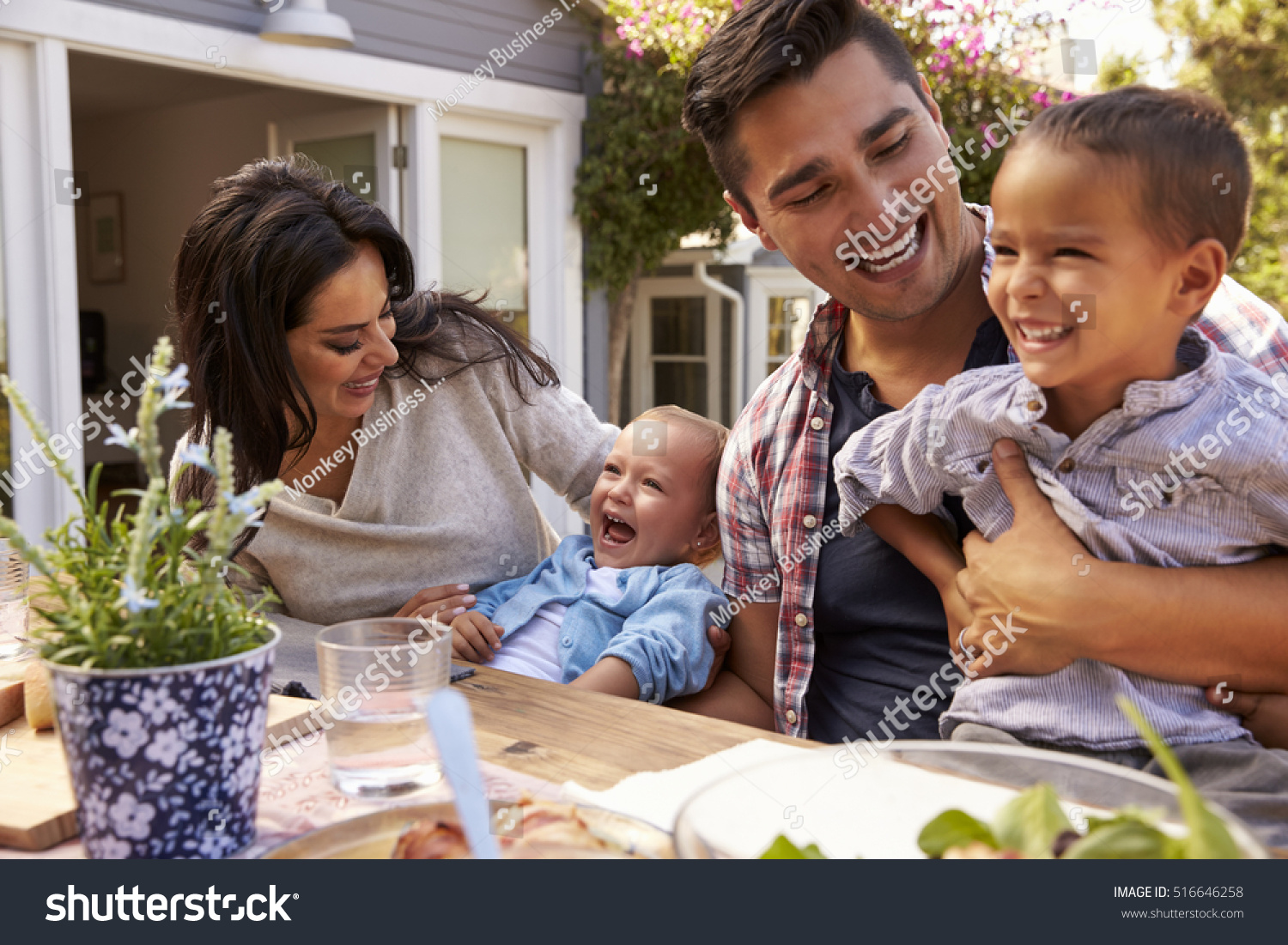 group-of-families-enjoying-outdoor-meal-at-home-937805-stock-photo-at